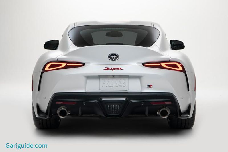 The image features a white Toyota Supra, showcasing its modern aesthetics and performance-oriented design.