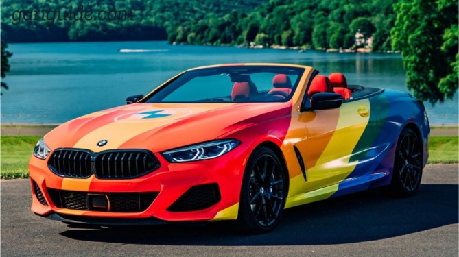 A BMW convertible painted in rainbow colors, representing a popular BMW model in Pakistan.