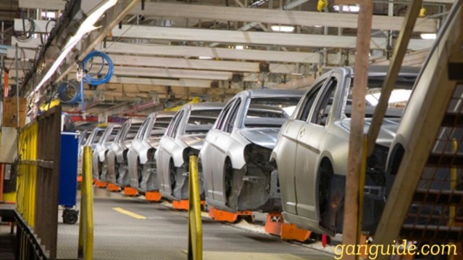 A row of cars in a factory showcasing its body design.