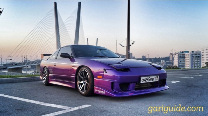 A purple Nissan 180SX parked in front of a bridge, showcasing its sleek design and also the Nissan 180SX price in Pakistan.