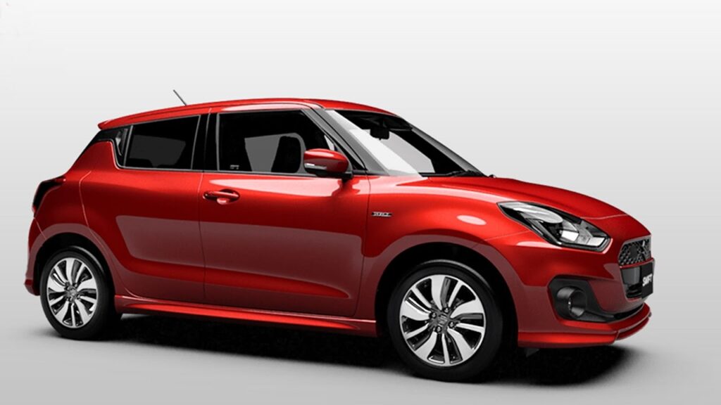 Red Suzuki Swift parked on the roadside in Pakistan
